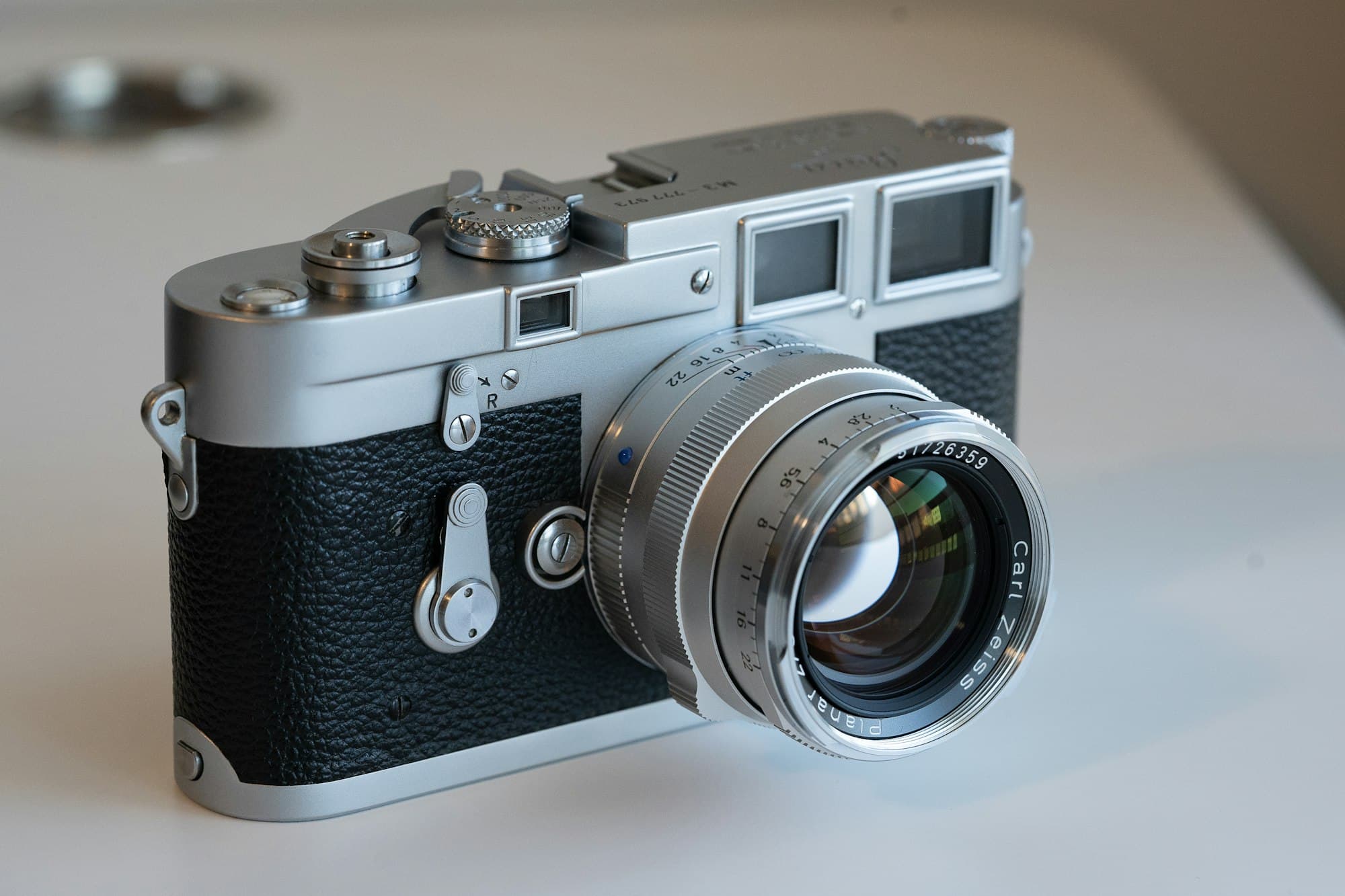 A silver Leica M3 rangefinder with a Zeiss Planar lens, listed as K-0412